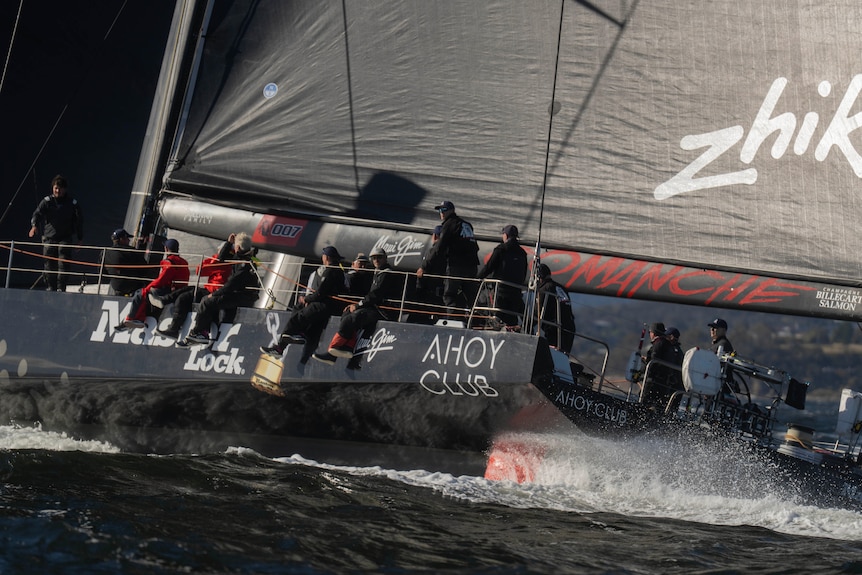 a group sitting on a black yacht