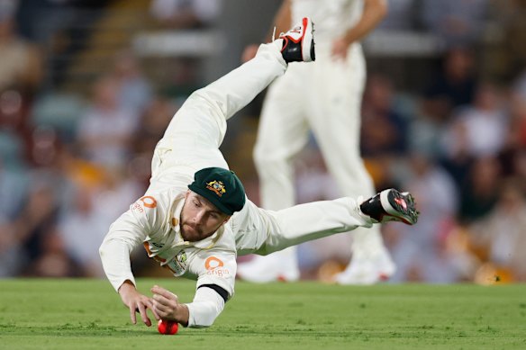 Josh Inglis dives to stop a single.