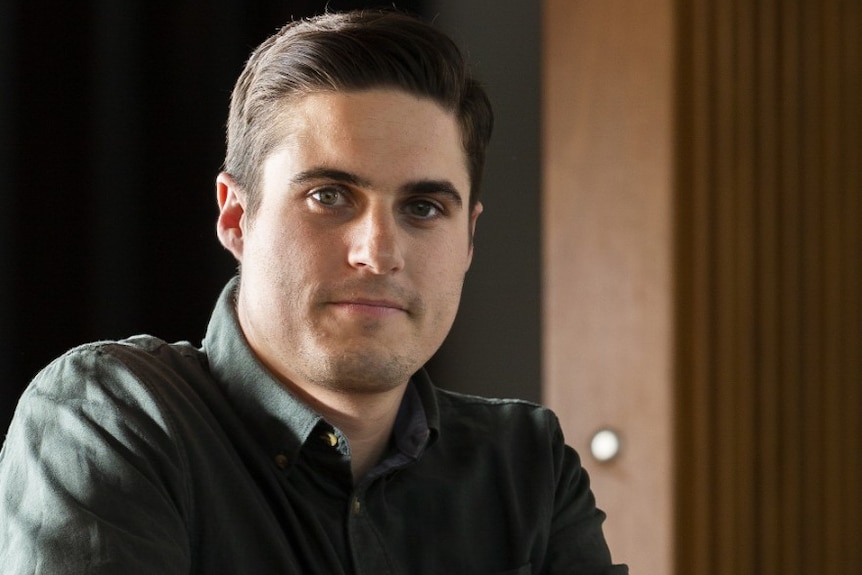 Frank Iorfino looks pensive as he holds a mobile in his hand