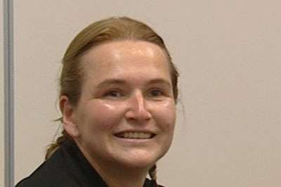 A profile picture of a woman smiling at the camera.