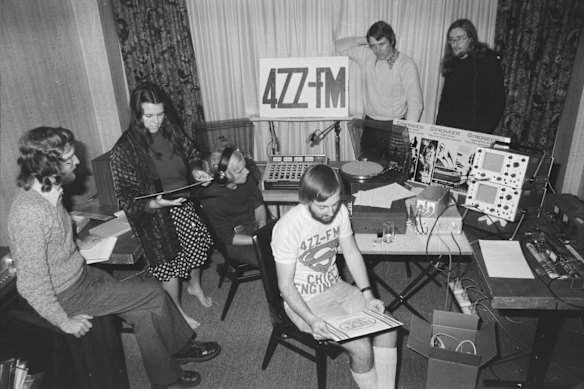 Volunteers, announcer Helen Hambling (second left) and station engineer Ross Dannecker (centre) getting ready for a 4ZZ-FM (4ZZZ) test broadcast, 1975.