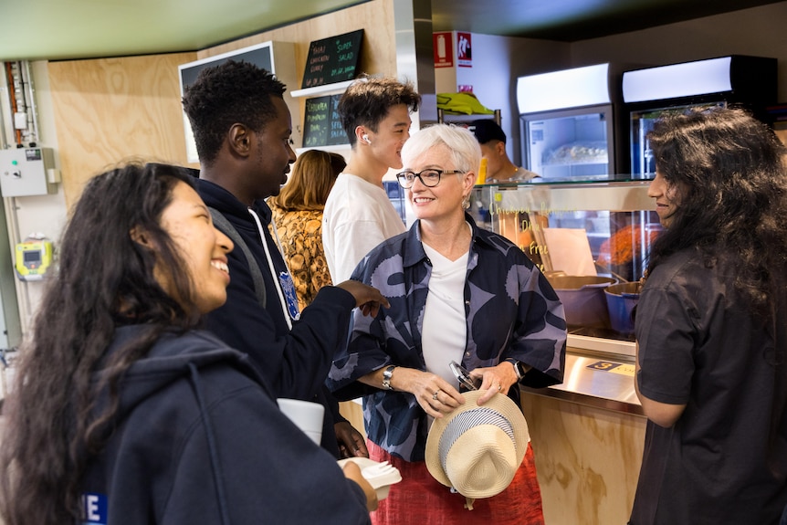 Emma Johnston speaks with young university students.