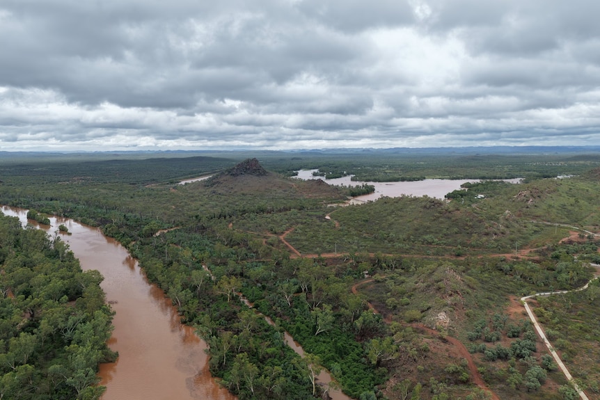An aerial view of a river and a dam with high water levels.