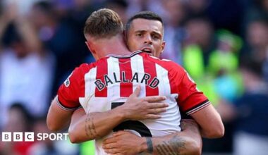 Dan Ballard hugs team-mate Granit Xhaka on the pitch