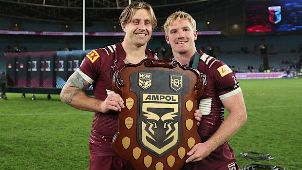 Cameron Munster and Tom Dearden of the Maroons celebrate with the State of Origin Shield.