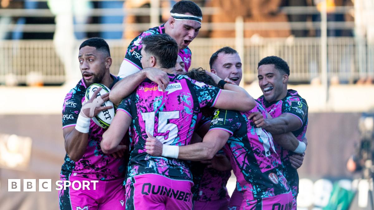 Six Ospreys players in a huddle celebrating scoring a try in their win at Montauban in the Challenge Cup