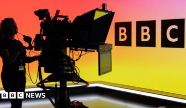 Ana, Viktoriia, and Khalil - Ana has dark hair and hospital pjs on, Viktoriia is wearing a blue top and holding a teddy bear and Khalil is wearing a red, white and blue top and has a hat on. All of them are smiling.