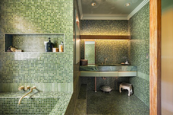 The green-tiled bathroom is a nod to the gum trees enveloping this coastal haven.