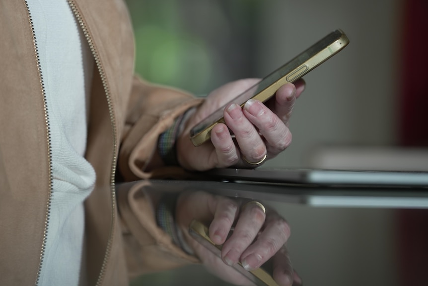 A close up of a hand holding a mobile phone.