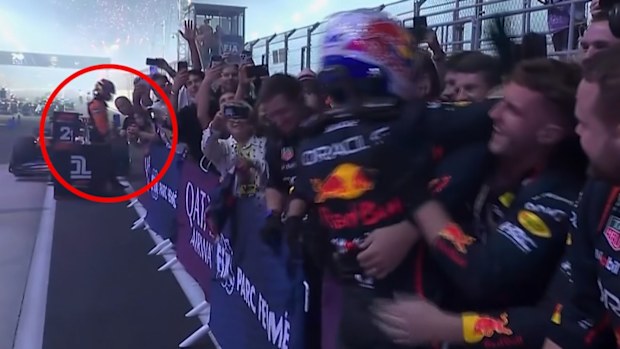A lonely Oscar Piastri was visible in the background of Max Verstappen's celebrations with his team.