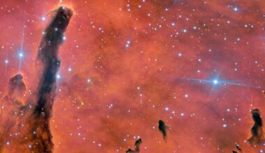 pillars of gas and dust against a fiery pink and orange background