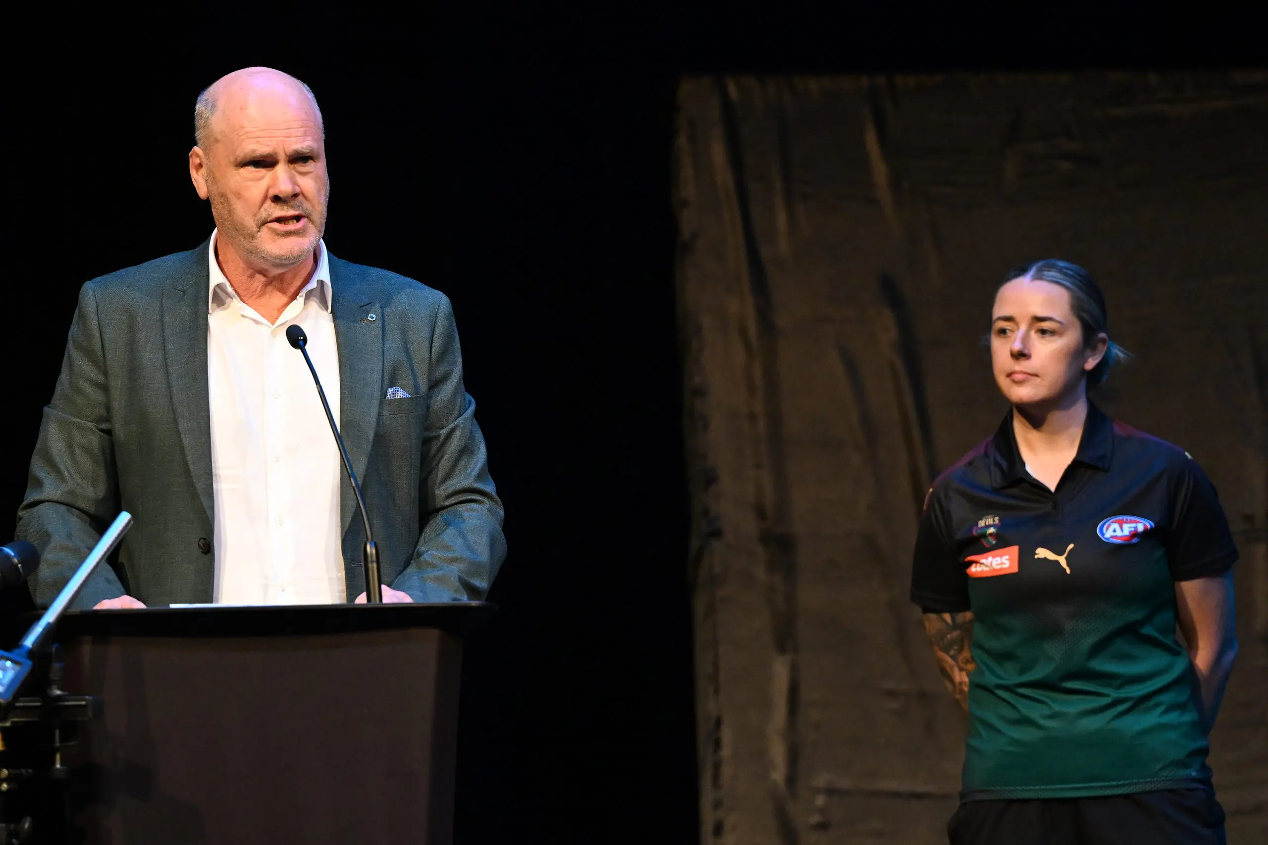 VARIOUS CITIES, AUSTRALIA - MARCH 18: Rodney Eade and Jessica Wuetschner prepare to unveil the new team colours during a media opportunity announcing the details for the Tasmanian AFL team, at Hobart Theatre Royal on March 18, 2024 in Various Cities, Australia. (Photo by Steve Bell/Getty Images)