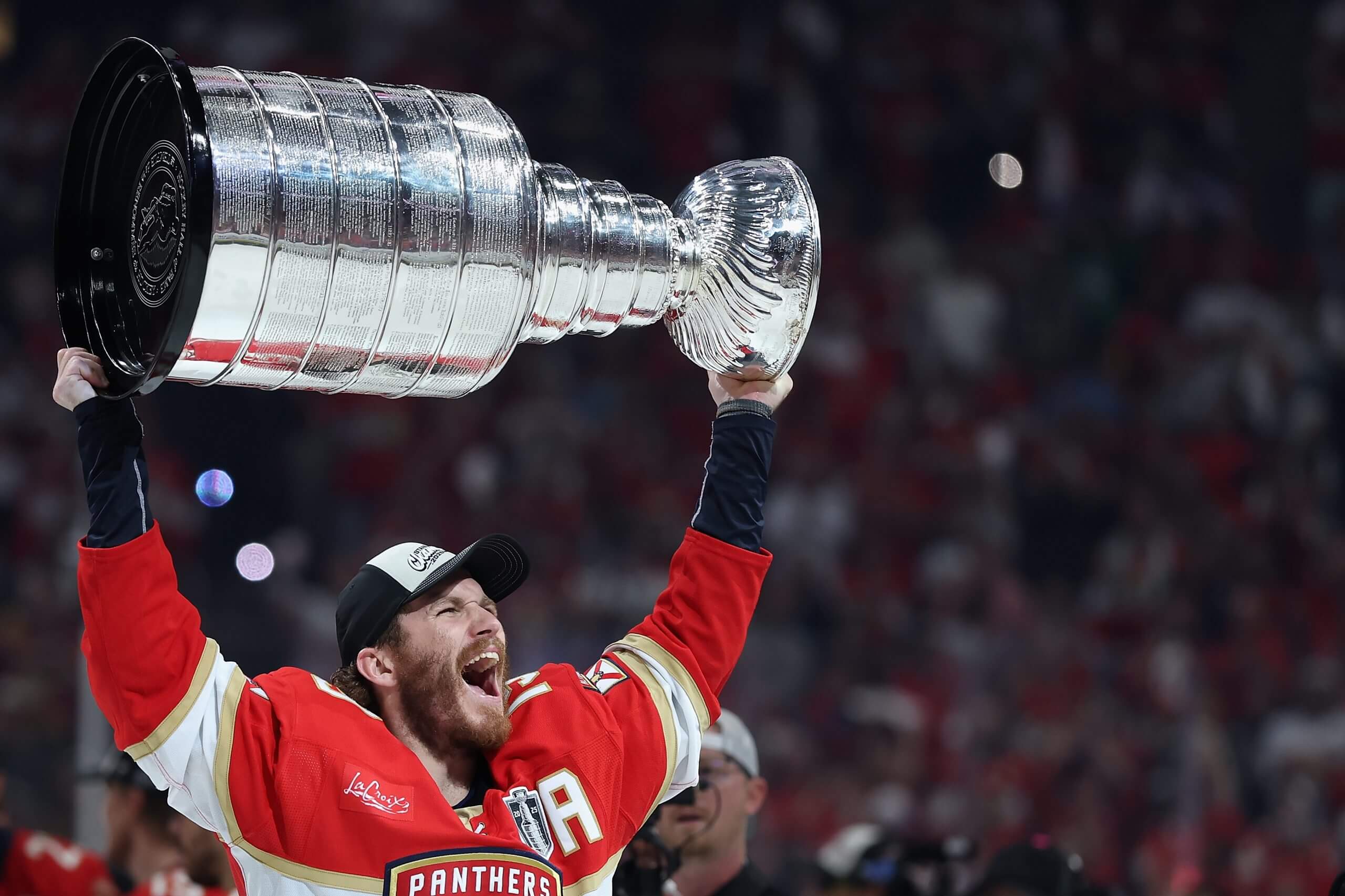 Matthew Tkachuck lifts the Stanley Cup over his head.