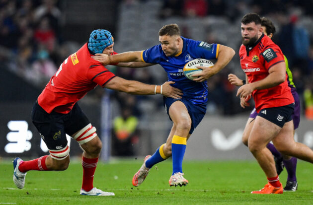 Jordan Larmour of Leinster is tackled by Munster players during the October 2025 URC match