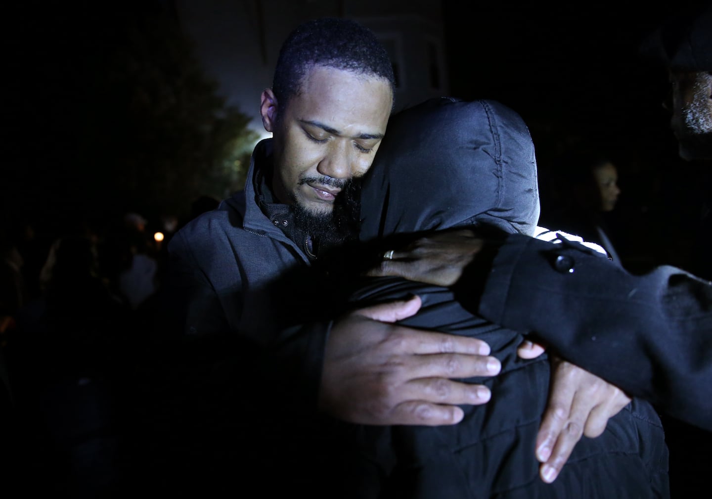 Edson Brito embraced a family member following a vigil in memory of his two sons in Brockton on Feb. 8, 2018. 