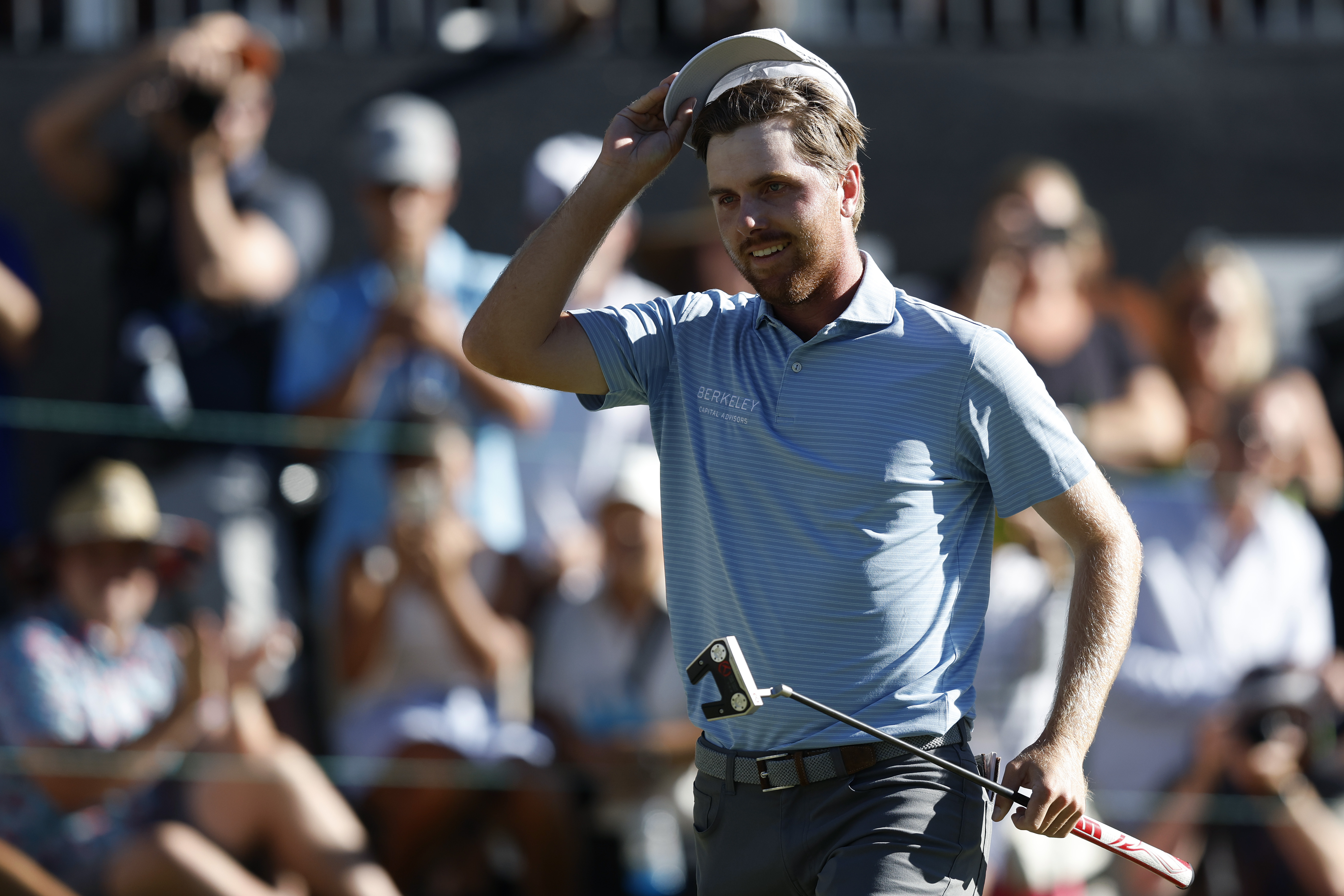 Ryan Gerard taps his cap walking off the green