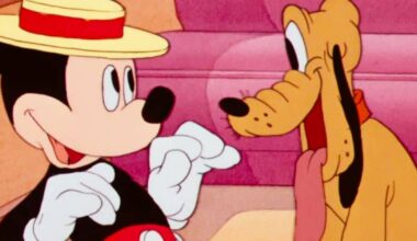 Pluto stares at Mickey wearing a hat in an animated short