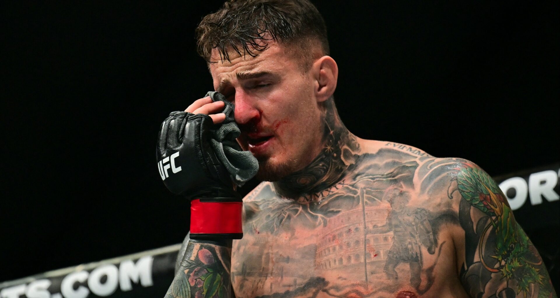 Tom Aspinall reacts after getting poked in the eyes during his fight at UFC 321