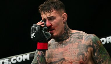 Tom Aspinall reacts after getting poked in the eyes during his fight at UFC 321