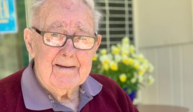 Owen Todd with the 100 year Queenstown Bowling Club history that he wrote for the 2004 celebration copy