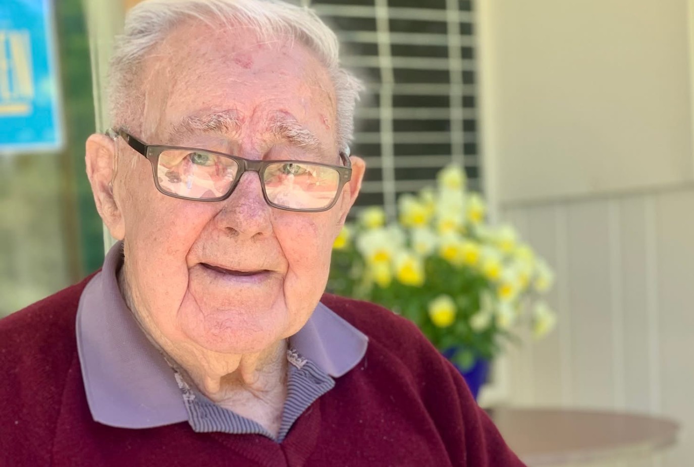 Owen Todd with the 100 year Queenstown Bowling Club history that he wrote for the 2004 celebration copy