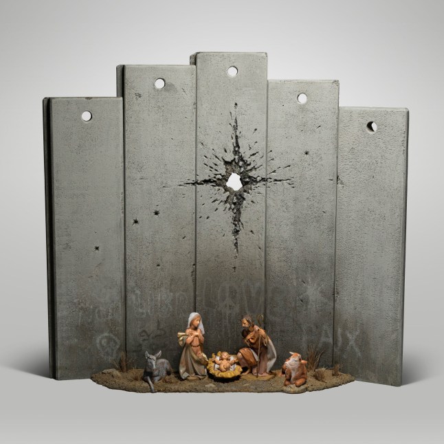 Undated handout photo issued by Banksy of his new artwork titled Scar of Bethlehem. The piece has appeared in the Walled Off Hotel, Banksy's hotel that overlooks the Bethlehem wall and features a nativity scene with Mary and Joseph and the baby Jesus. PA Photo. Issue date: Saturday December 21, 2019. However, instead of a star hanging over the crib, there is what appears to be a large bullet hole piercing the centre of an imposing grey wall. See PA story ARTS Banksy. Photo credit should read: Banksy/PA Wire NOTE TO EDITORS: This handout photo may only be used in for editorial reporting purposes for the contemporaneous illustration of events, things or the people in the image or facts mentioned in the caption. Reuse of the picture may require further permission from the copyright holder.