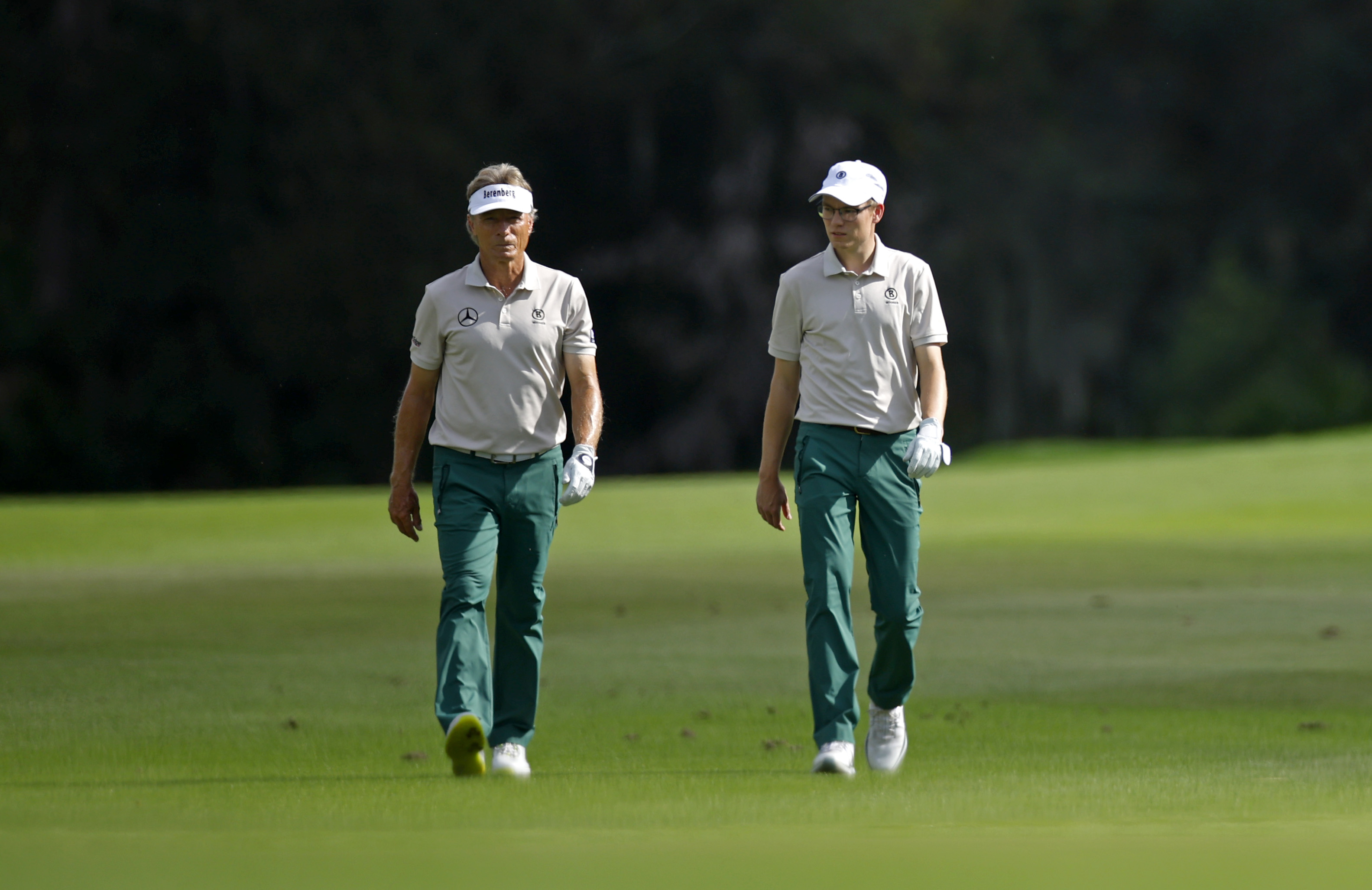 Bernhard and Jason Langer walk down the fairway