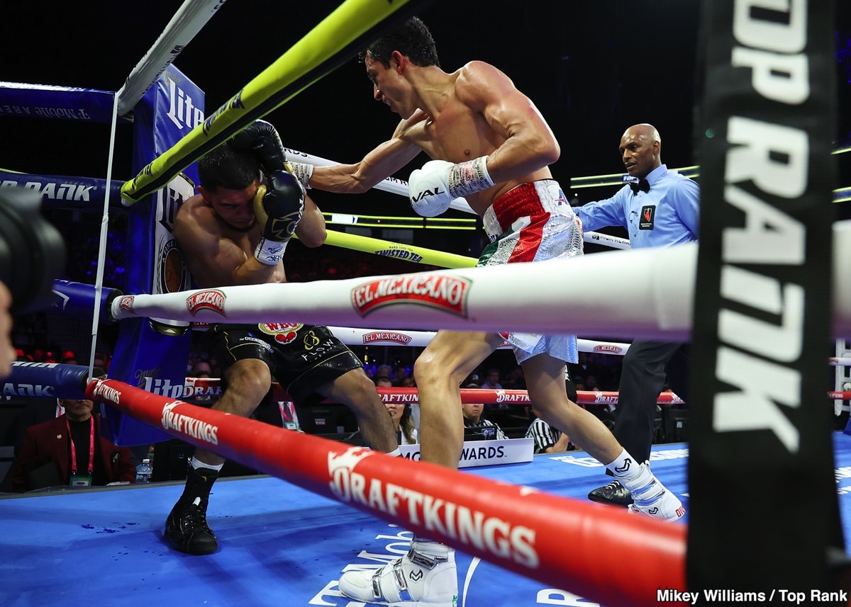 Rafael Espinoza throws a right hand at Edward Vazquez along the ropes during their featherweight bout at T-Mobile Arena in Las Vegas.