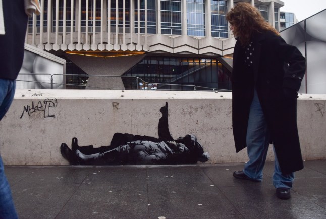 A new artwork, suspected to be by elusive street artist Banksy, has appeared outside Centre Point and Tottenham Court Road Station. The artwork depicts two children lying on their backs and pointing upwards. Suspected New Banksy Artwork Outside Centre Point, London.