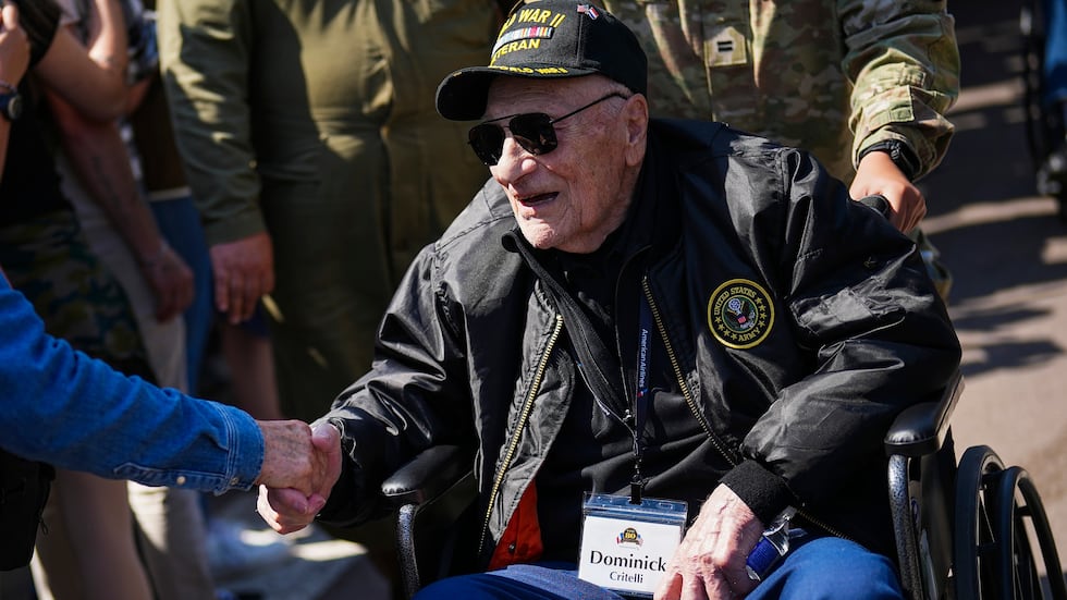 FILE -- U.S. World War II veteran Dominick Critelli is greeted by the crowd during an American...