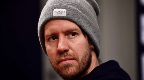 Vettel looking forward wearing a grey hat
