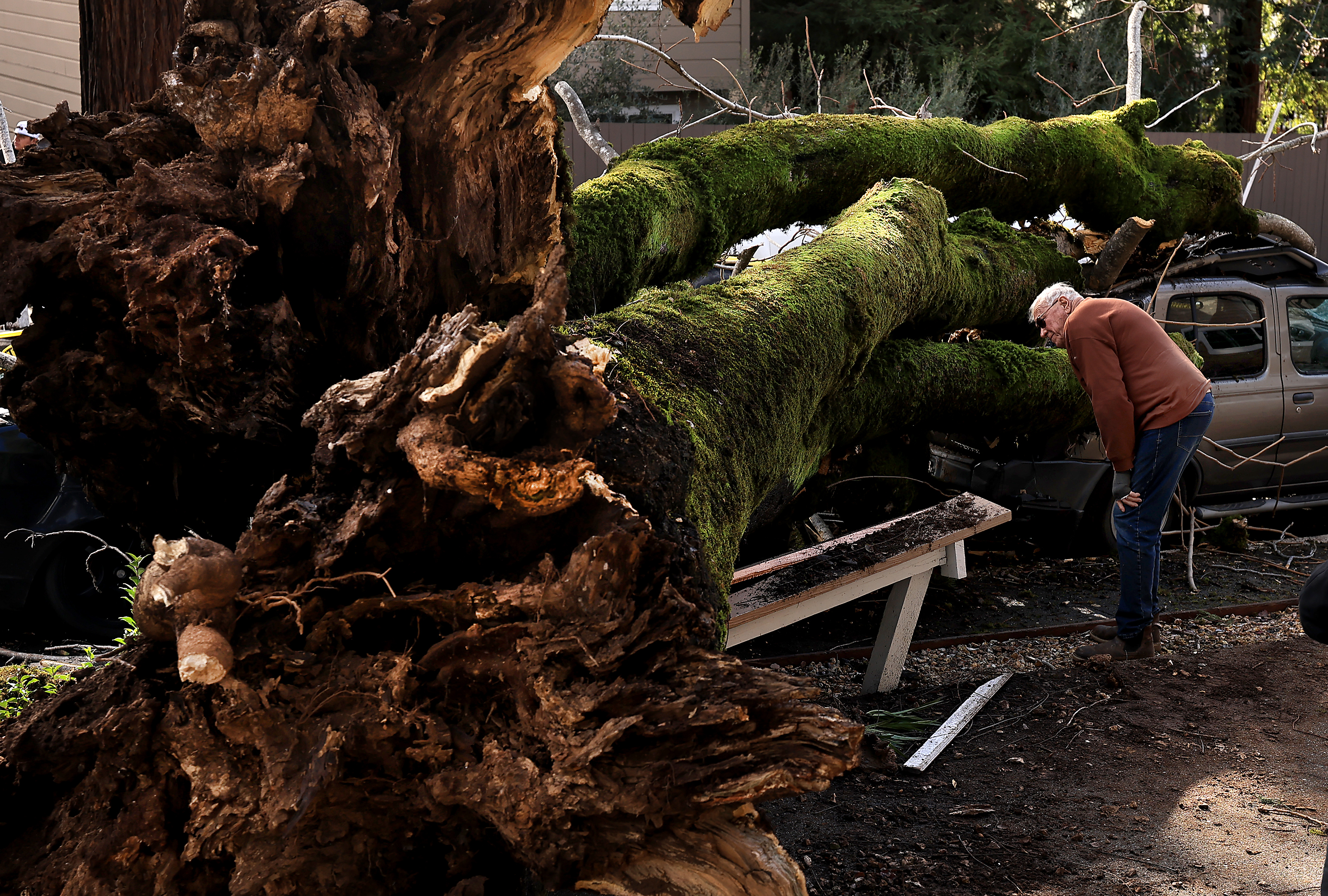 Glenn Benjamin, inspects damage to his tenants vehicles at the...
