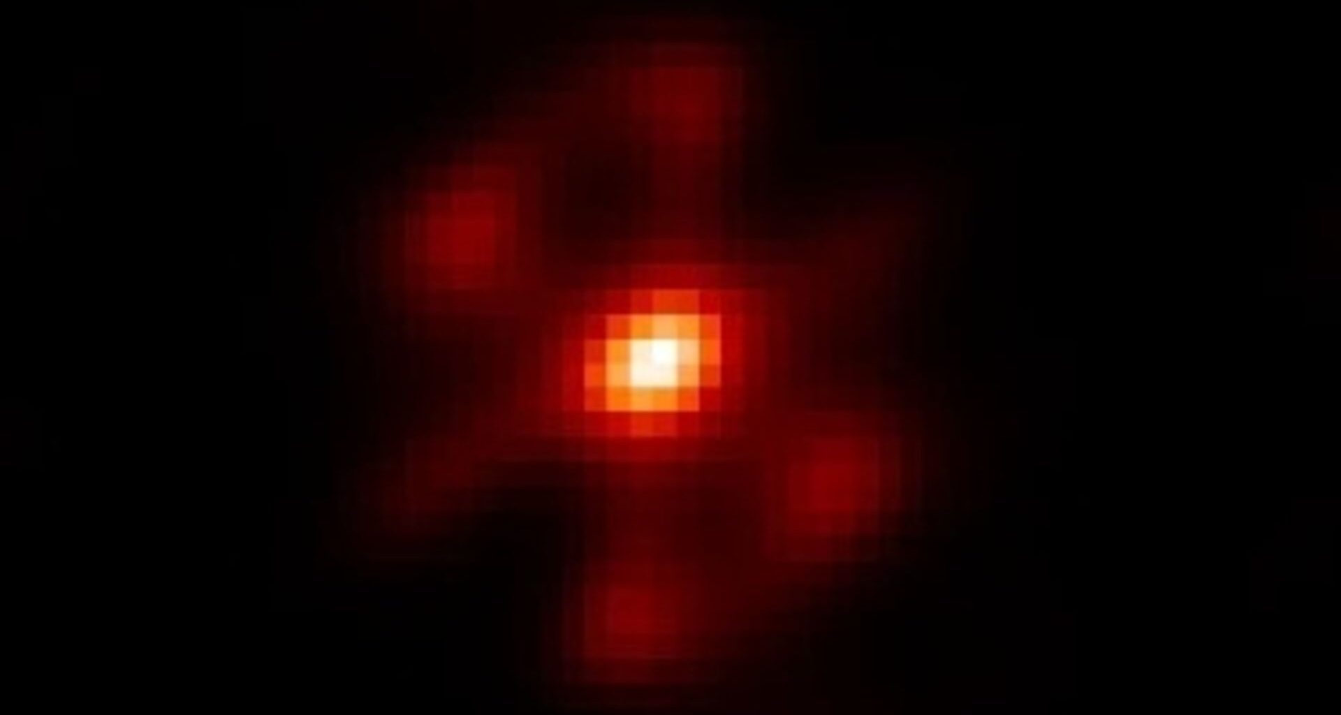 A pixelated image showing a white dot surrounding by orange and red light against a black background