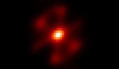 A pixelated image showing a white dot surrounding by orange and red light against a black background
