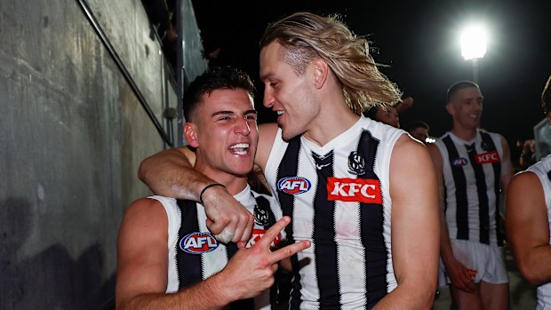 Nick Daicos and Darcy Moore embrace.