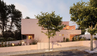 atelier RUA's pink house contrasts with its surroundings in portugal