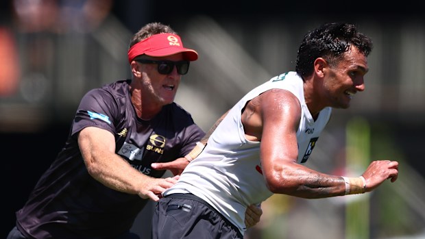 Head coach, Damien Hardwick and Jamarra Ugle-Hagan during a Gold Coast Suns AFL training session at People First Stadium on December 01, 2025 in Gold Coast, Australia. (Photo by Chris Hyde/Getty Images)