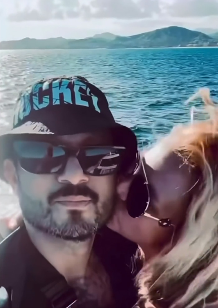 Britney Spears shares a yacht kiss with a mystery man, sparking concern among fans over her bikini slip incident.