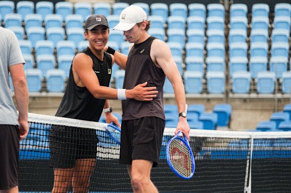 Alex de Minaur and Rinky Hijikata share a moment at the net following a practice session in Sydney.