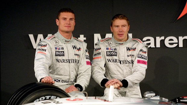 McLaren drivers David Coulthard and Mika Hakkinen pose with the new McLaren Mercedes in 2001. 