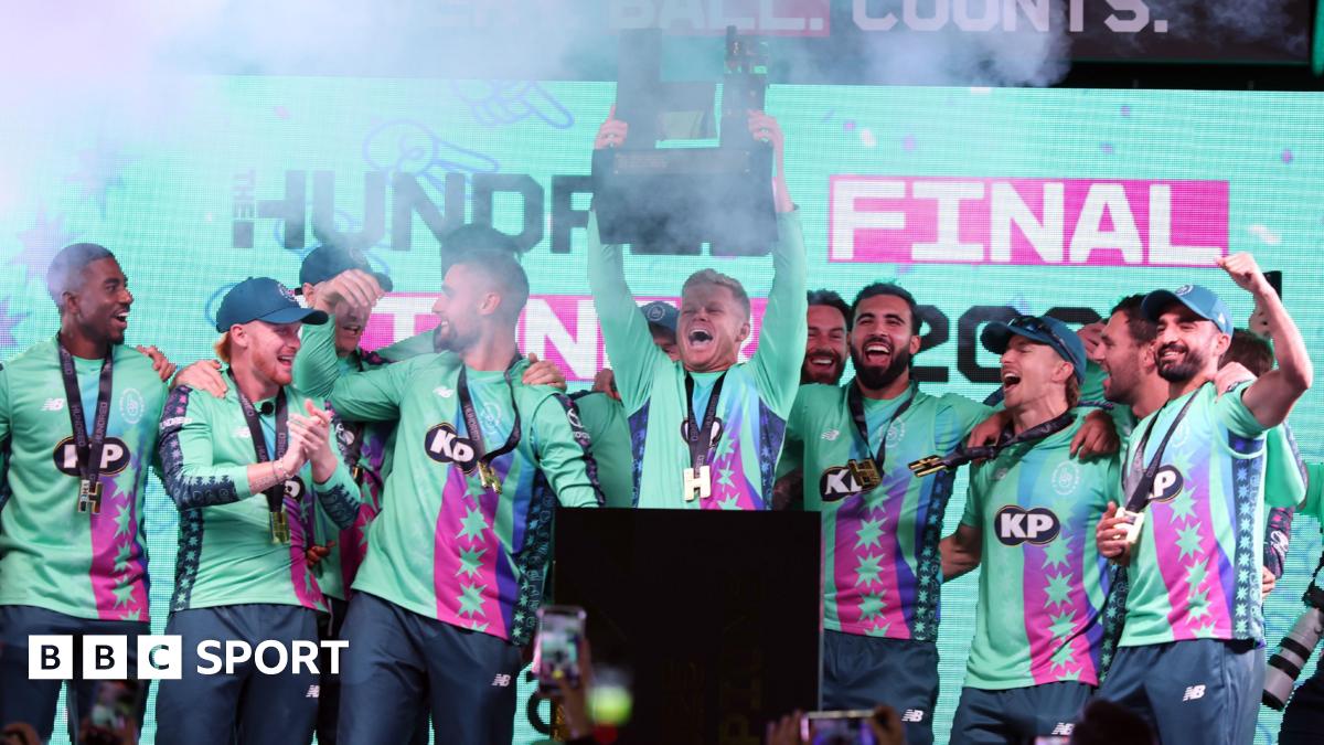 Sam Billings lifts The Hundred trophy surrounded by his Oval Invincibles team-mates.