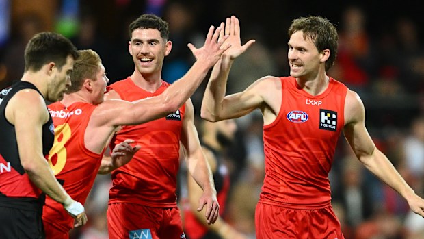 Noah Anderson of the Suns celebrates kicking a goal.