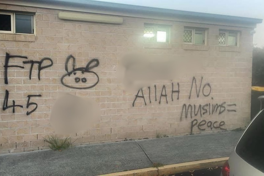 Blurred graffiti on a brick wall.