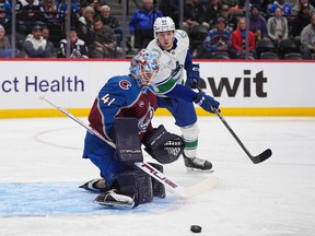 Colorado Avalanche goaltender Scott Wedgewood, front, deflects a shot from Linus Karlsson in the second period
