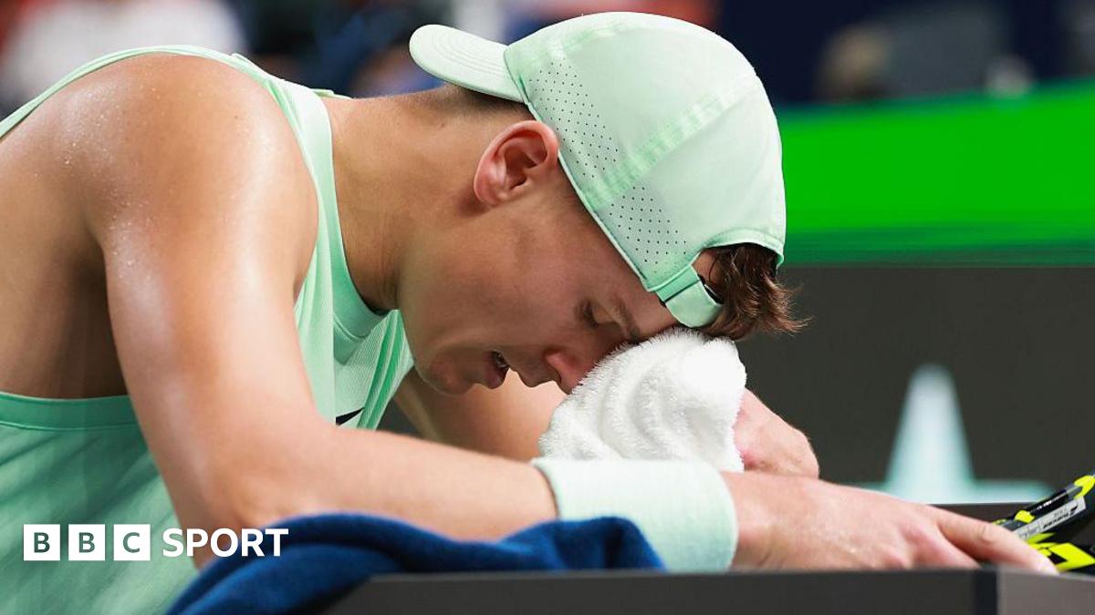 Holger Rune wipes his forehead with a towel during the Shanghai Masters