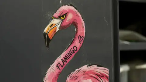 Moose Campbell/BBC A Flamingo is painted on the side of a cupboard at a secret Ukrainian missile factory