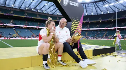 Getty Images Meg Jones and John Mitchell holding the trophy