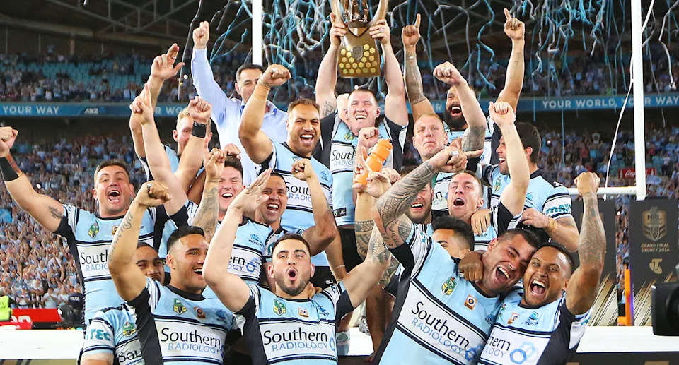 Ricky Leutele with Cronulla Sharks teammates after the 2016 NRL grand final.