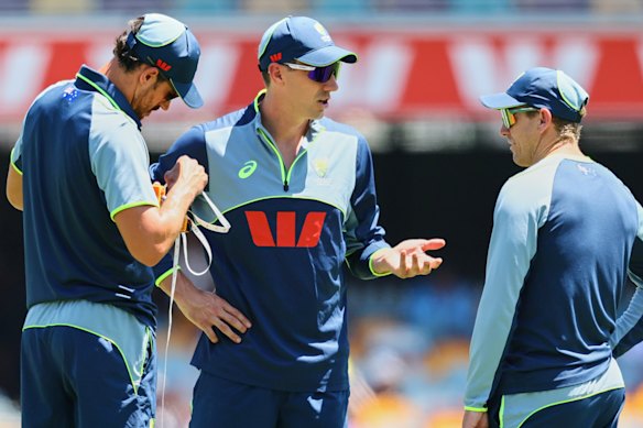 Pat Cummins (centre) before the start of play.