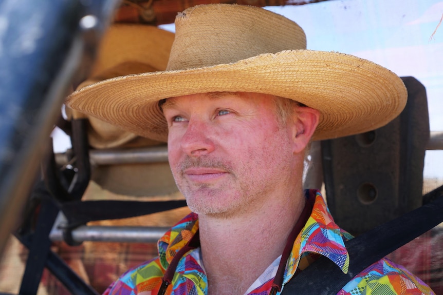 A man in large hat and a colourful shirt.